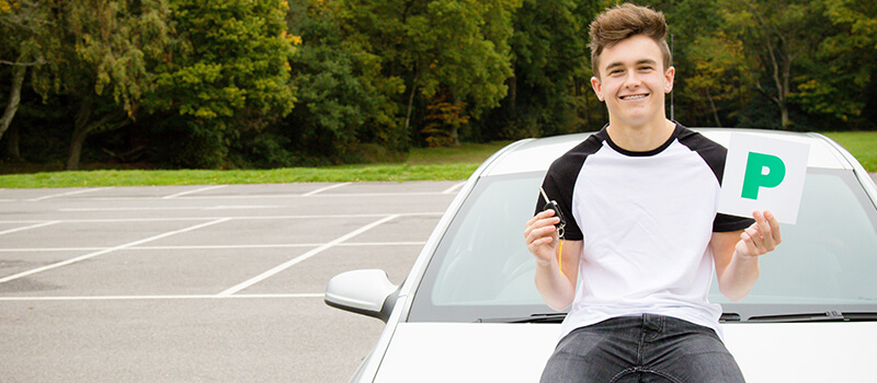 boy sitting on car with p-plates